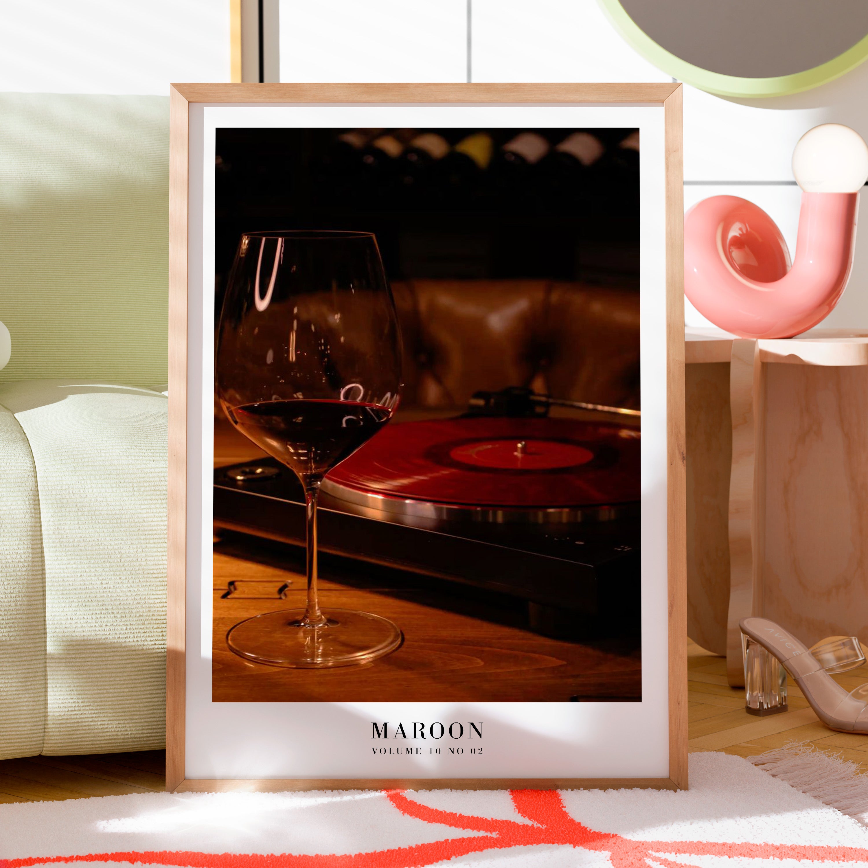Maroon vinyl wine print displayed in moody apartment gallery wall