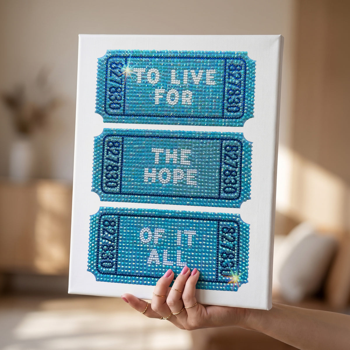 DIY craft kit by Haus of Moods featuring a rhinestone canvas with colorful bead designs and a partially completed bedazzle project.