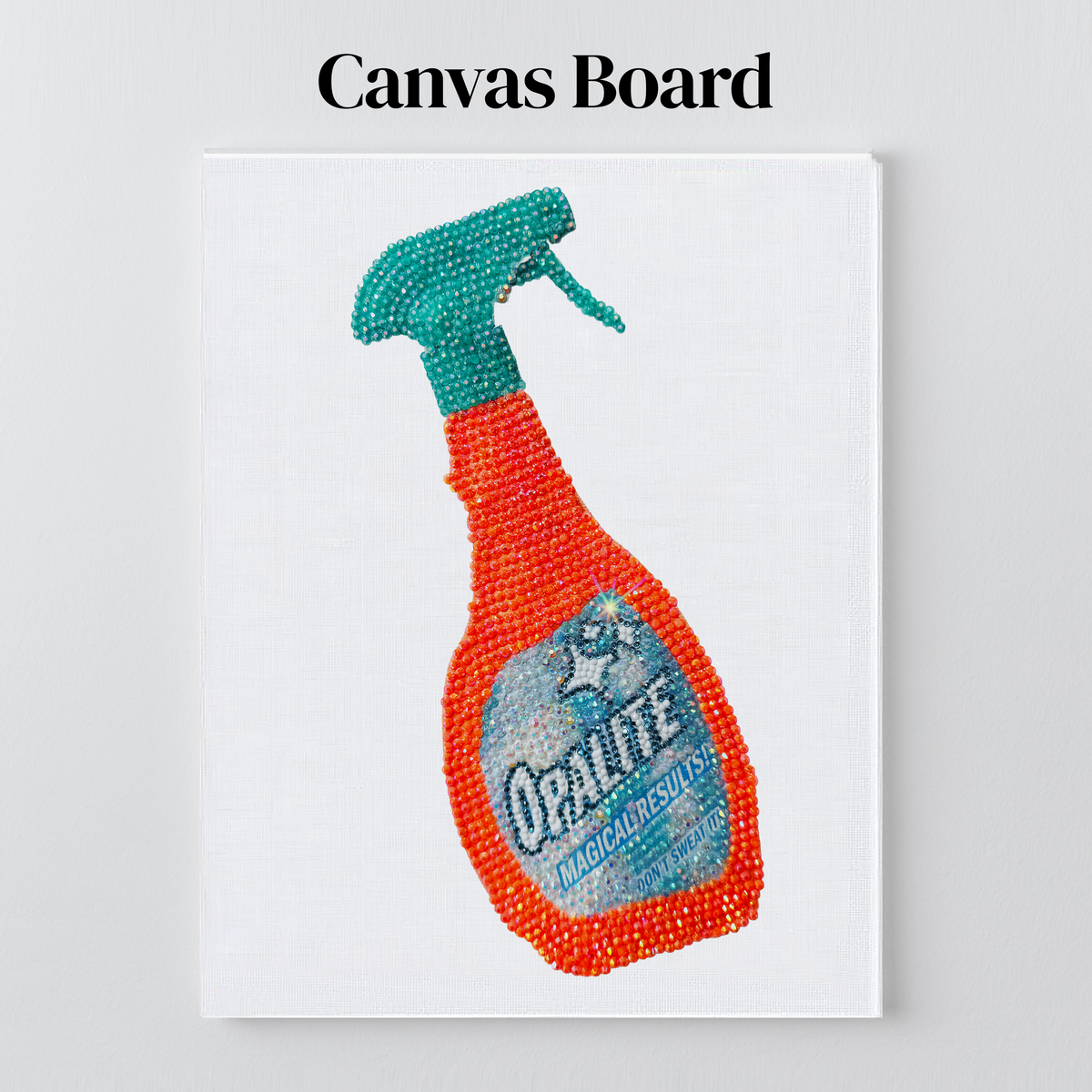 Opalite spray bottle rhinestone art on a flat canvas board, ready to frame