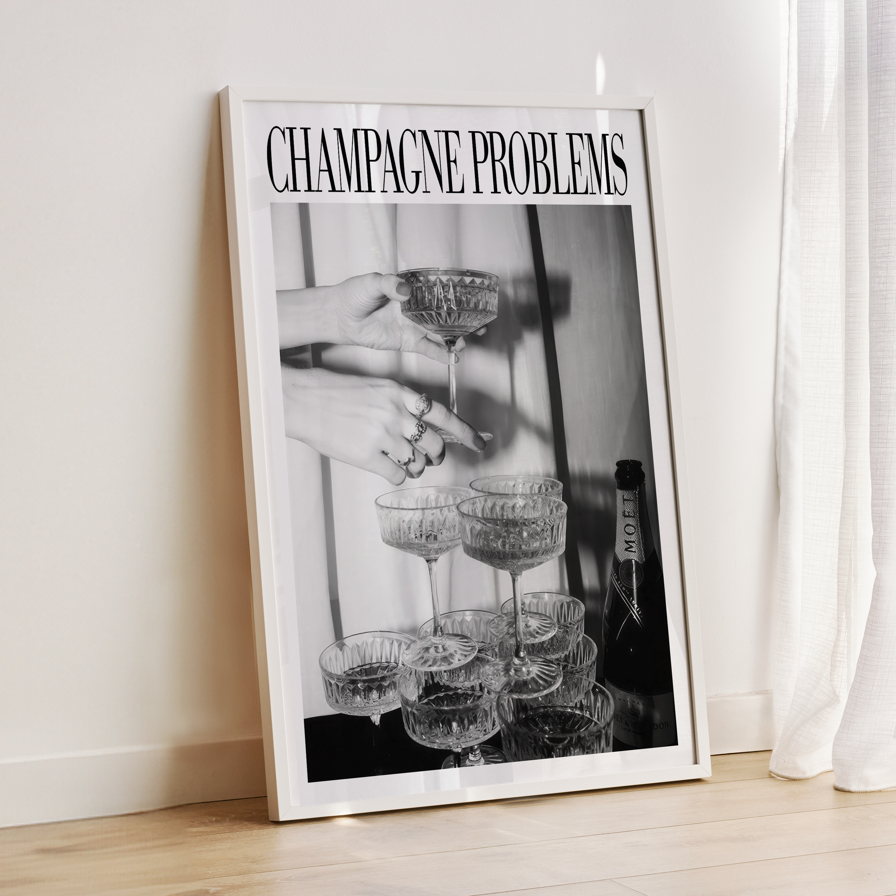 Framed poster titled 'Champagne Problems' with a black and white photo of hands holding champagne glasses.